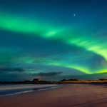 Northern lights, beautiful landscape of a green light in the night starry sky, amazing natural beauty of Lofoten archipelago, Gimsoya, Norway